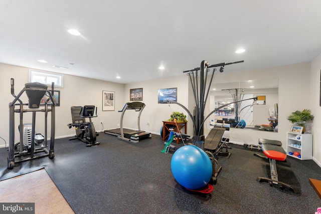 exercise room with recessed lighting and baseboards