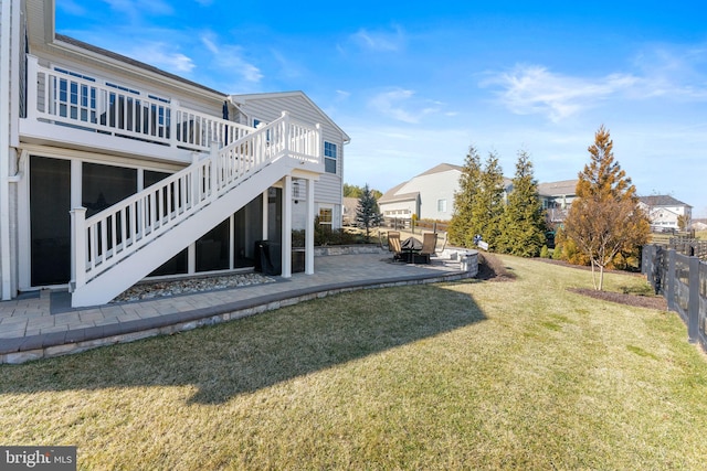 view of yard with a patio area, stairs, fence, and a deck