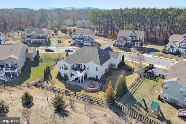 drone / aerial view with a residential view and a view of trees