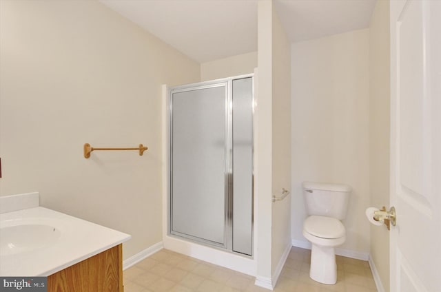 full bathroom with toilet, a shower stall, baseboards, and vanity