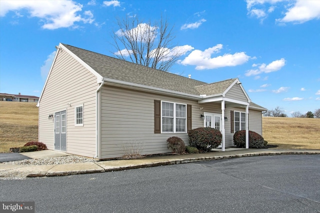 view of property exterior featuring roof with shingles