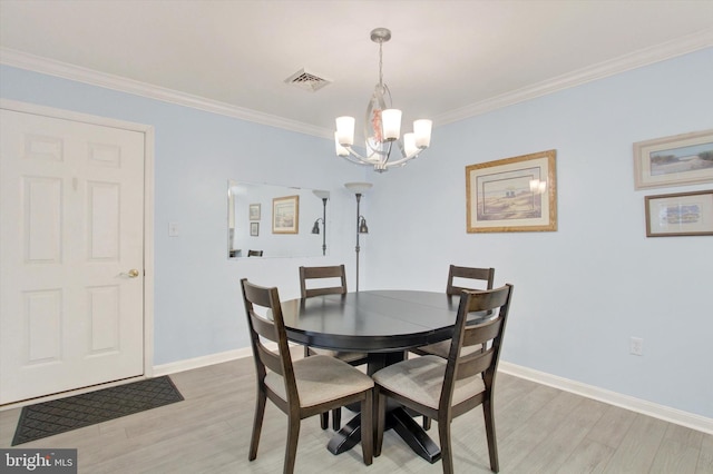 dining area with light wood finished floors, baseboards, visible vents, crown molding, and a notable chandelier