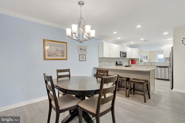 dining room featuring baseboards, crown molding, recessed lighting, and light wood-style floors