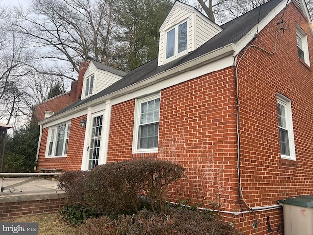 view of property exterior with brick siding