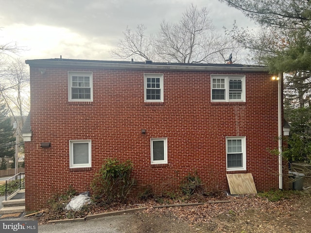 view of side of home featuring brick siding
