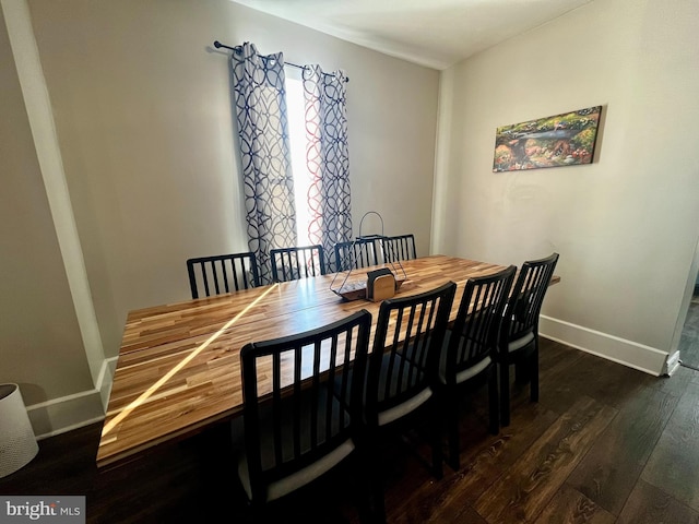 dining room featuring baseboards and wood finished floors