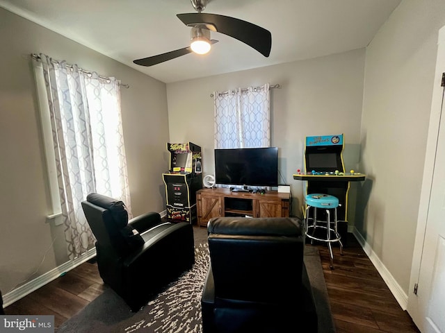 living room with baseboards, a ceiling fan, and wood finished floors