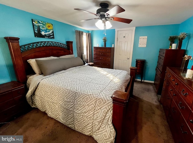 bedroom with a ceiling fan, dark colored carpet, and baseboards