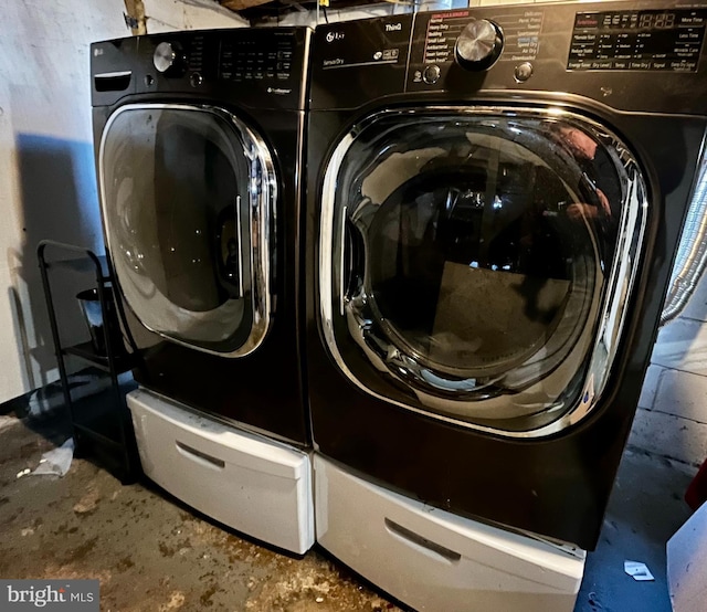 washroom featuring laundry area and separate washer and dryer