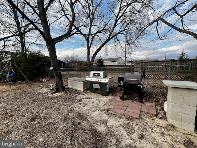 view of yard featuring fence and a playground