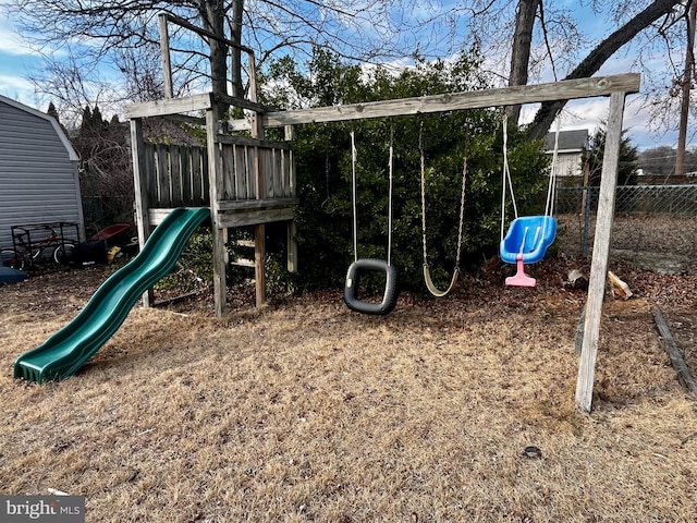 view of jungle gym featuring fence