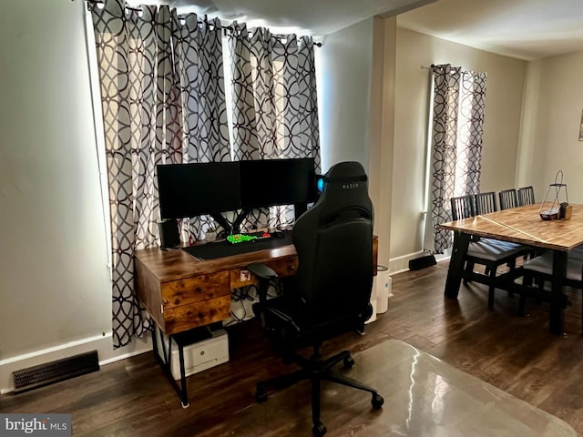 office with visible vents, baseboards, and wood finished floors