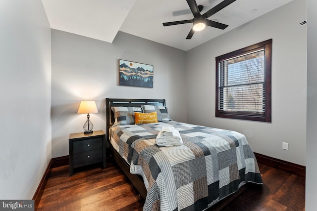 bedroom with a ceiling fan, wood finished floors, and baseboards