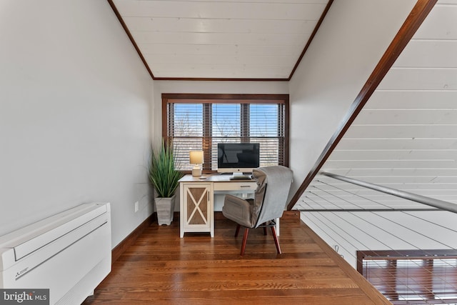 office space featuring crown molding, lofted ceiling, and wood finished floors