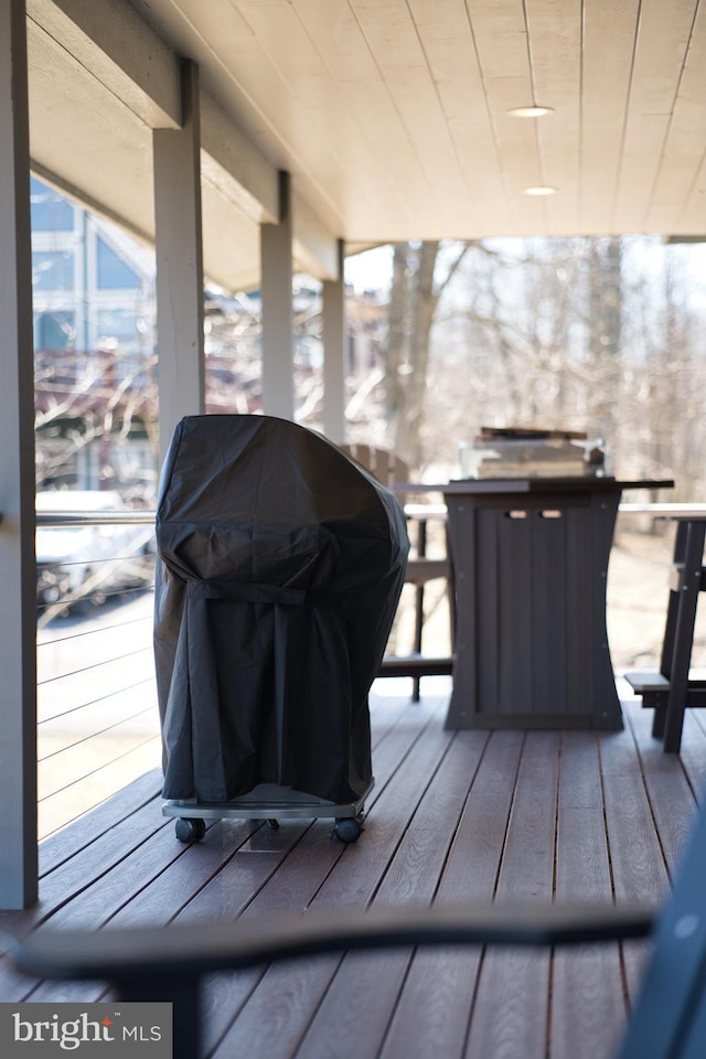 wooden terrace featuring a grill