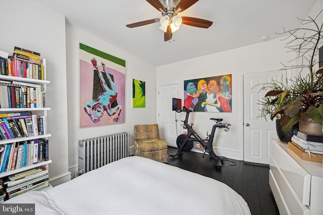 bedroom with radiator heating unit, ceiling fan, and hardwood / wood-style floors