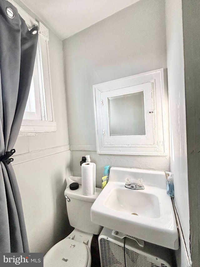 half bath with toilet and a sink