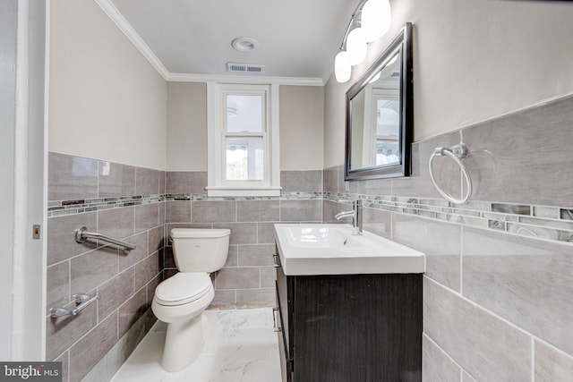 bathroom featuring marble finish floor, visible vents, toilet, ornamental molding, and vanity