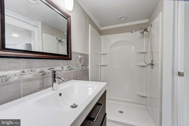 full bath featuring a shower, tile walls, vanity, and crown molding