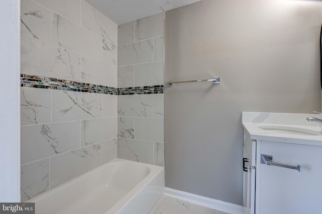 bathroom featuring marble finish floor, shower / bathing tub combination, vanity, and baseboards