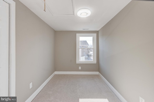 unfurnished room featuring carpet floors, visible vents, and baseboards