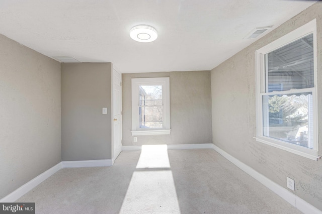 interior space with light carpet, visible vents, and baseboards