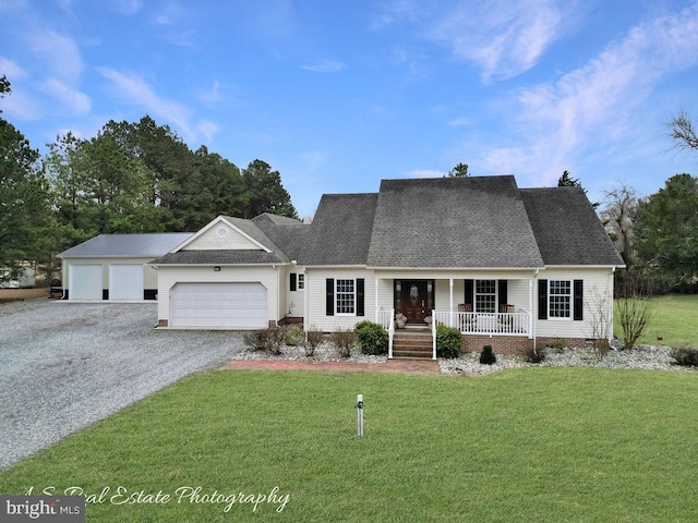 view of front facade with gravel driveway, a porch, a front yard, crawl space, and a garage