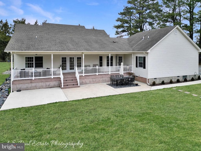 rear view of house with a shingled roof, french doors, crawl space, a lawn, and a patio area