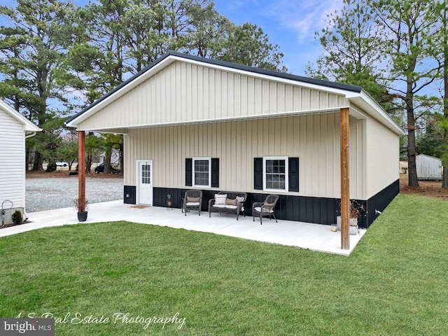 back of house featuring an outdoor hangout area, a patio, and a lawn