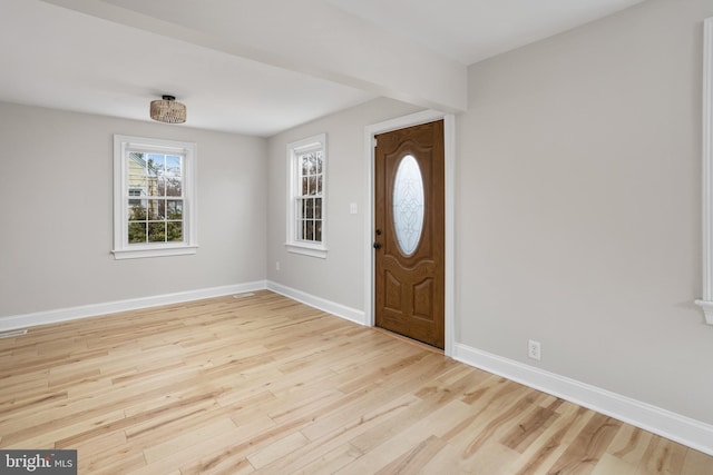 entrance foyer featuring baseboards and wood finished floors