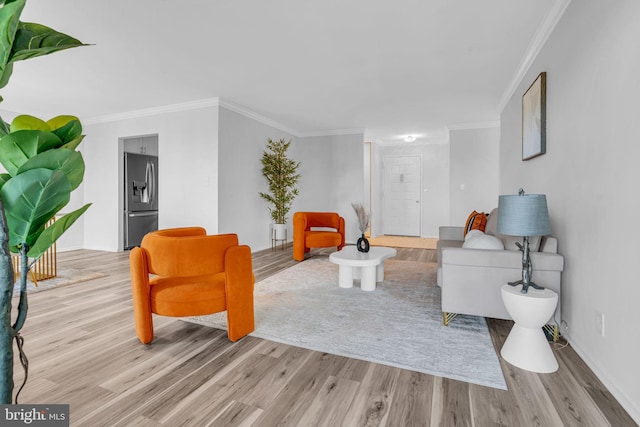 living room featuring light wood-style floors and ornamental molding