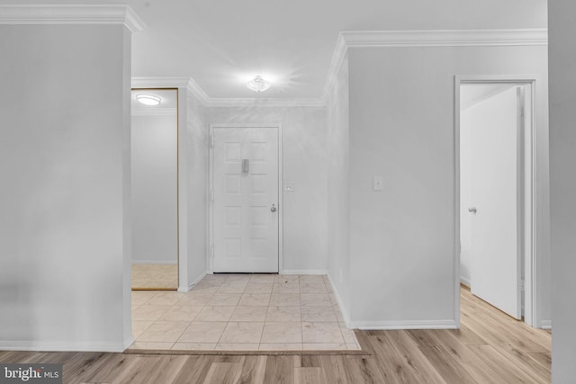 hallway with baseboards, wood finished floors, and crown molding