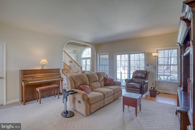 living area with stairs and baseboards