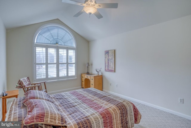 bedroom featuring carpet floors, vaulted ceiling, baseboards, and ceiling fan