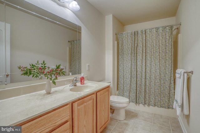 full bath featuring toilet, vanity, and tile patterned floors