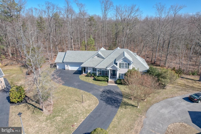 bird's eye view with a wooded view