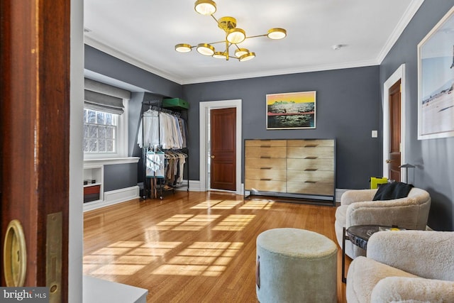 living area with crown molding, baseboards, and wood finished floors