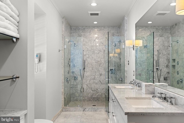 full bath featuring a stall shower, marble finish floor, visible vents, and a sink