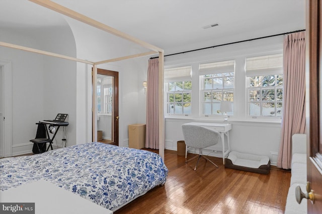 bedroom with hardwood / wood-style flooring and visible vents