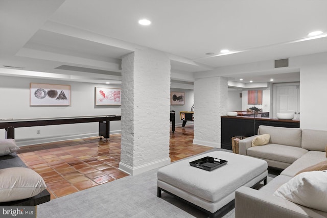 living room with baseboards, decorative columns, visible vents, and recessed lighting