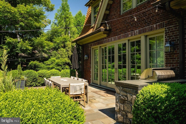 view of patio / terrace featuring outdoor dining area, area for grilling, and french doors