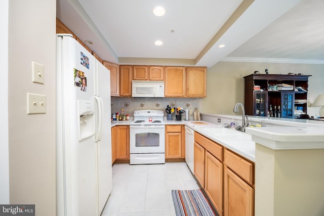 kitchen with a sink, tasteful backsplash, recessed lighting, white appliances, and light countertops