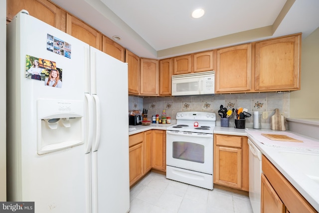 kitchen featuring recessed lighting, white appliances, backsplash, and light countertops