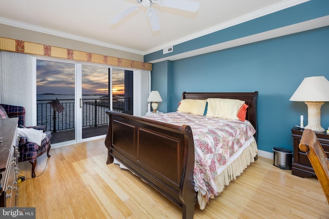 bedroom featuring visible vents, light wood finished floors, crown molding, and access to outside