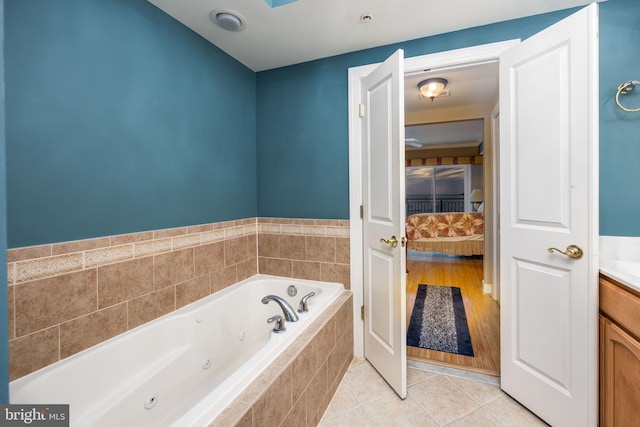 bathroom with tile patterned flooring, ensuite bath, vanity, and a whirlpool tub