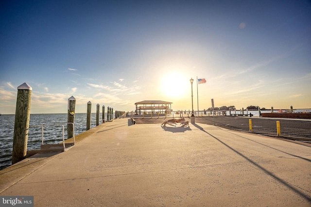 exterior space featuring a dock and a water view