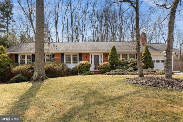 single story home featuring a garage, a front yard, a chimney, and brick siding