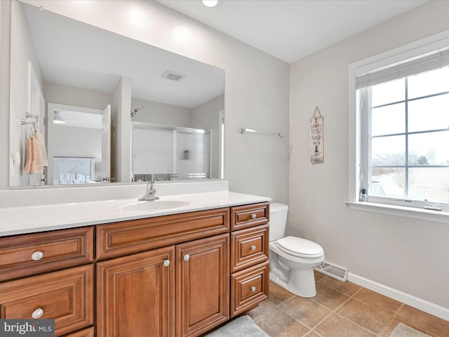 full bath featuring toilet, vanity, visible vents, and a shower with door