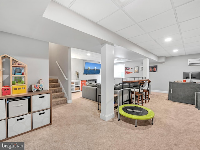 game room with carpet floors, a paneled ceiling, recessed lighting, a wall mounted AC, and baseboards