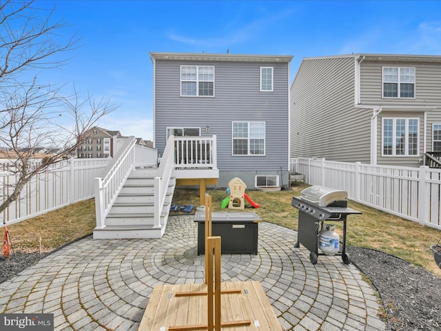 back of property featuring a fire pit, a fenced backyard, a patio, and a deck